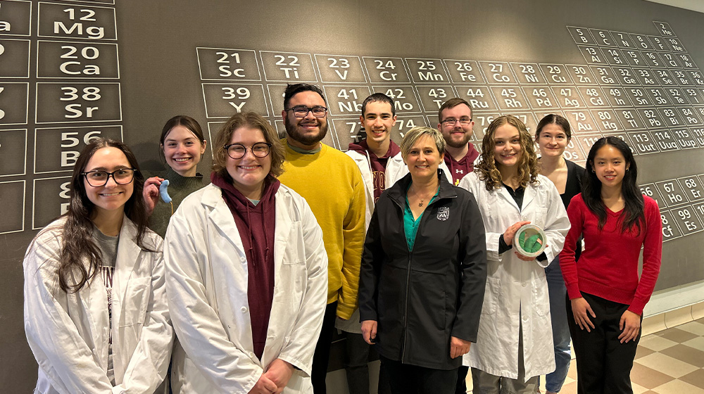 Polina Pine standing with Loyola students